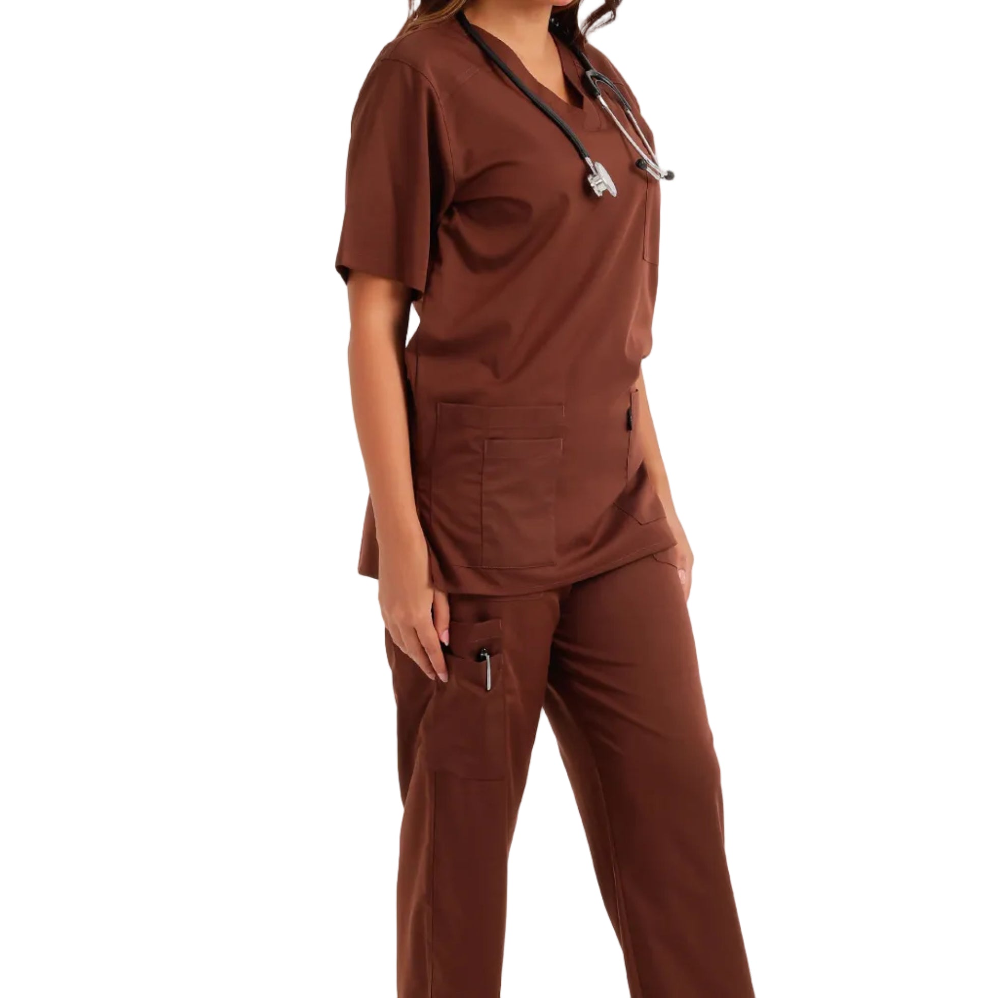 A woman modeling a matching brown scrub set consisting of a short-sleeve V-neck top and cargo-style pants, with a stethoscope around her neck, photographed against a clean white studio background.
